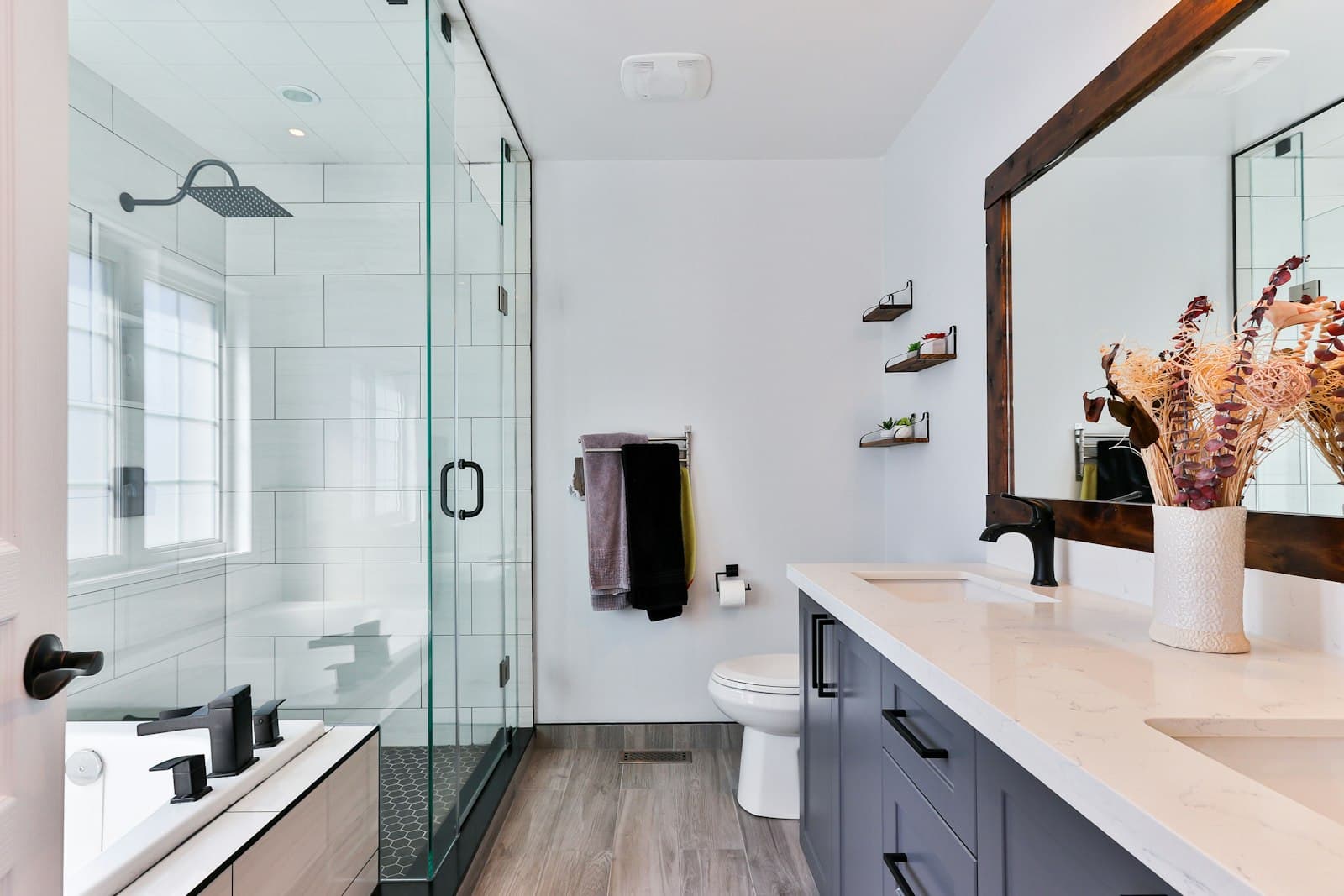 Tiled bathroom with a glass shower enclosure and vanity