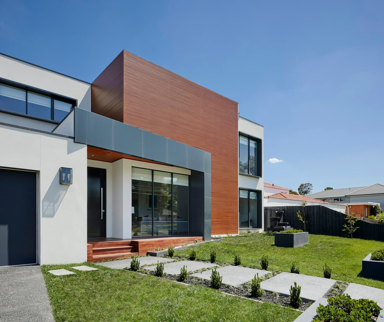 Modern independent house with a landscaped front lawn